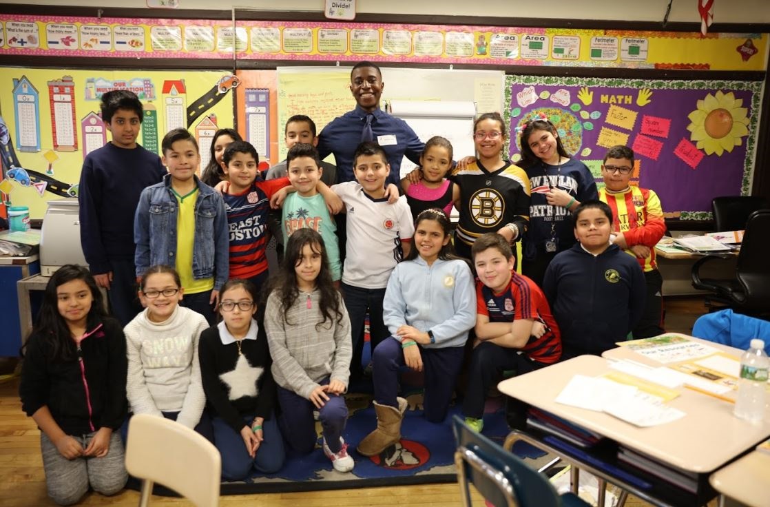 Brandon Samba with kids at the James Otis Elementary School in East Boston