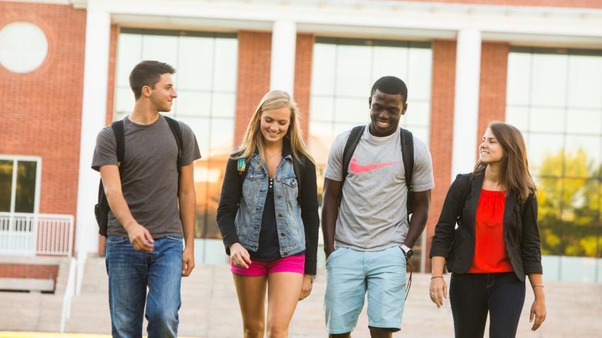 Group of students walking together on campus
