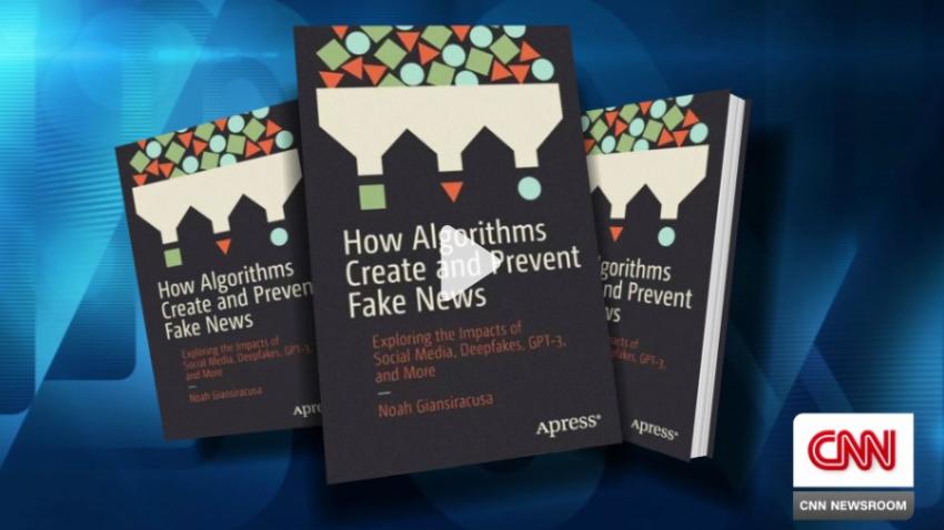 Screenshot of CNN video interview featuring still image with three copies of Noah Giansiracusa's book, "How Algorithms Create and Prevent Fake News"