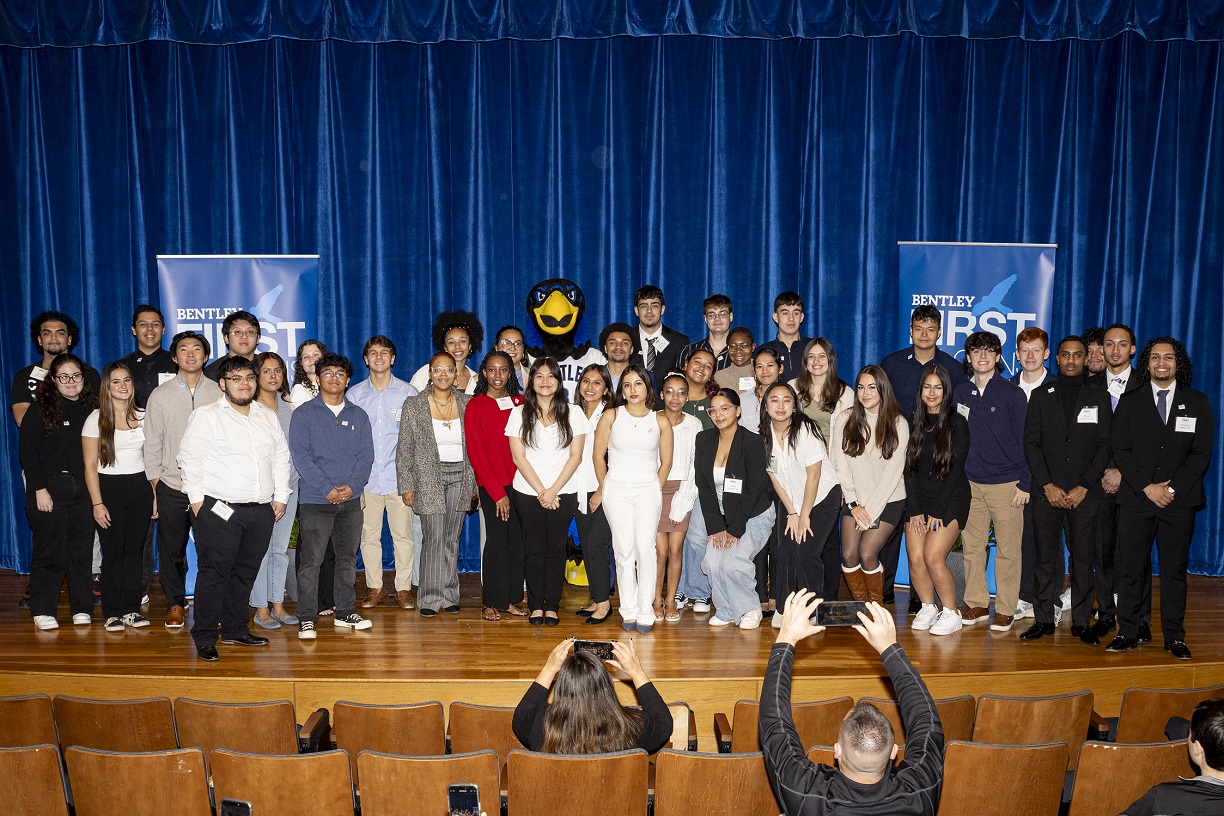 First-year First Falcons pose together with Flex the Falcon after the pinning ceremony.