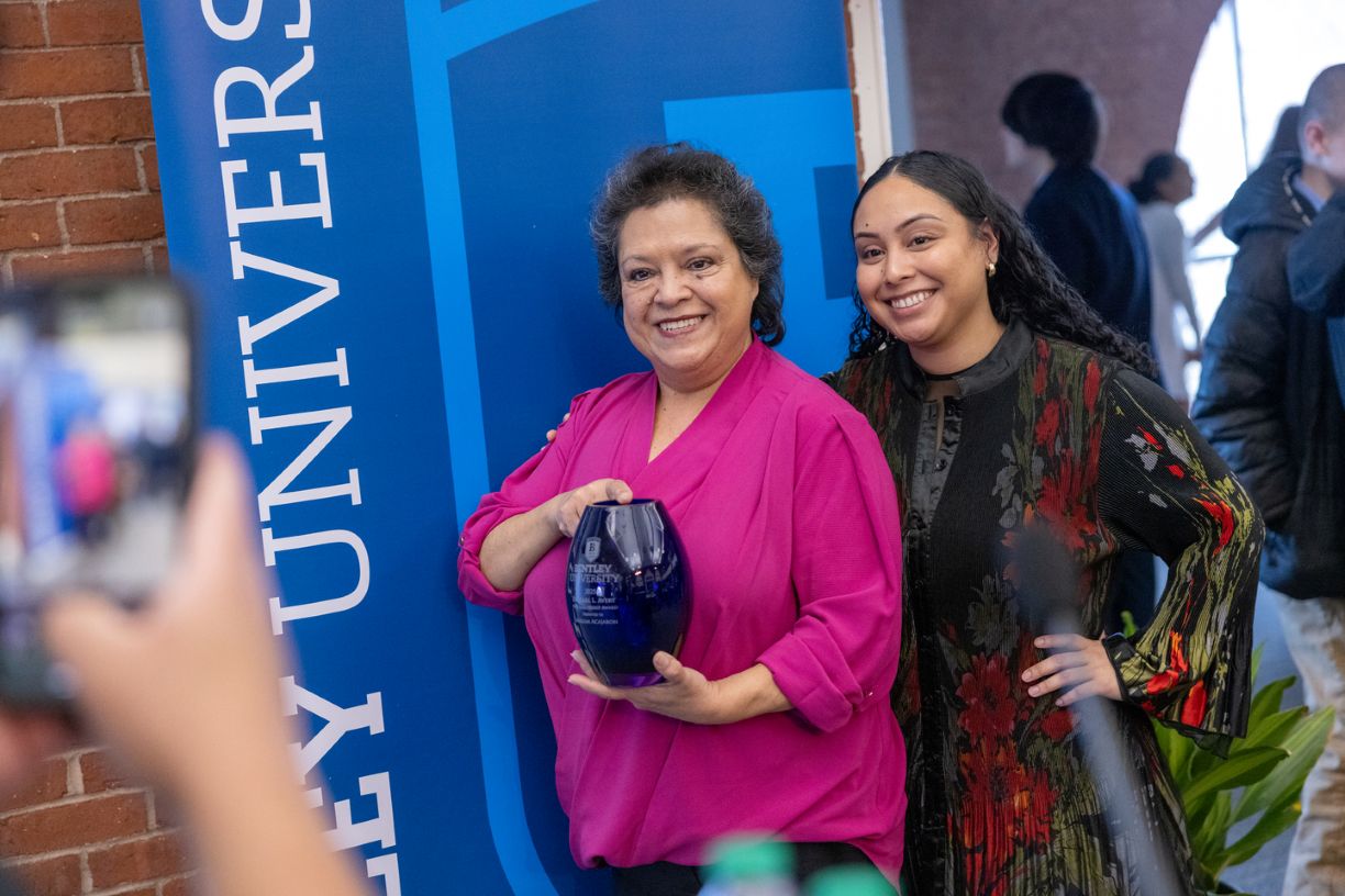 Bentley University staff member Miriam Acajabon poses with her Dr. Earl L. Avery MLK Leadership Award during the university’s annual MLK breakfast