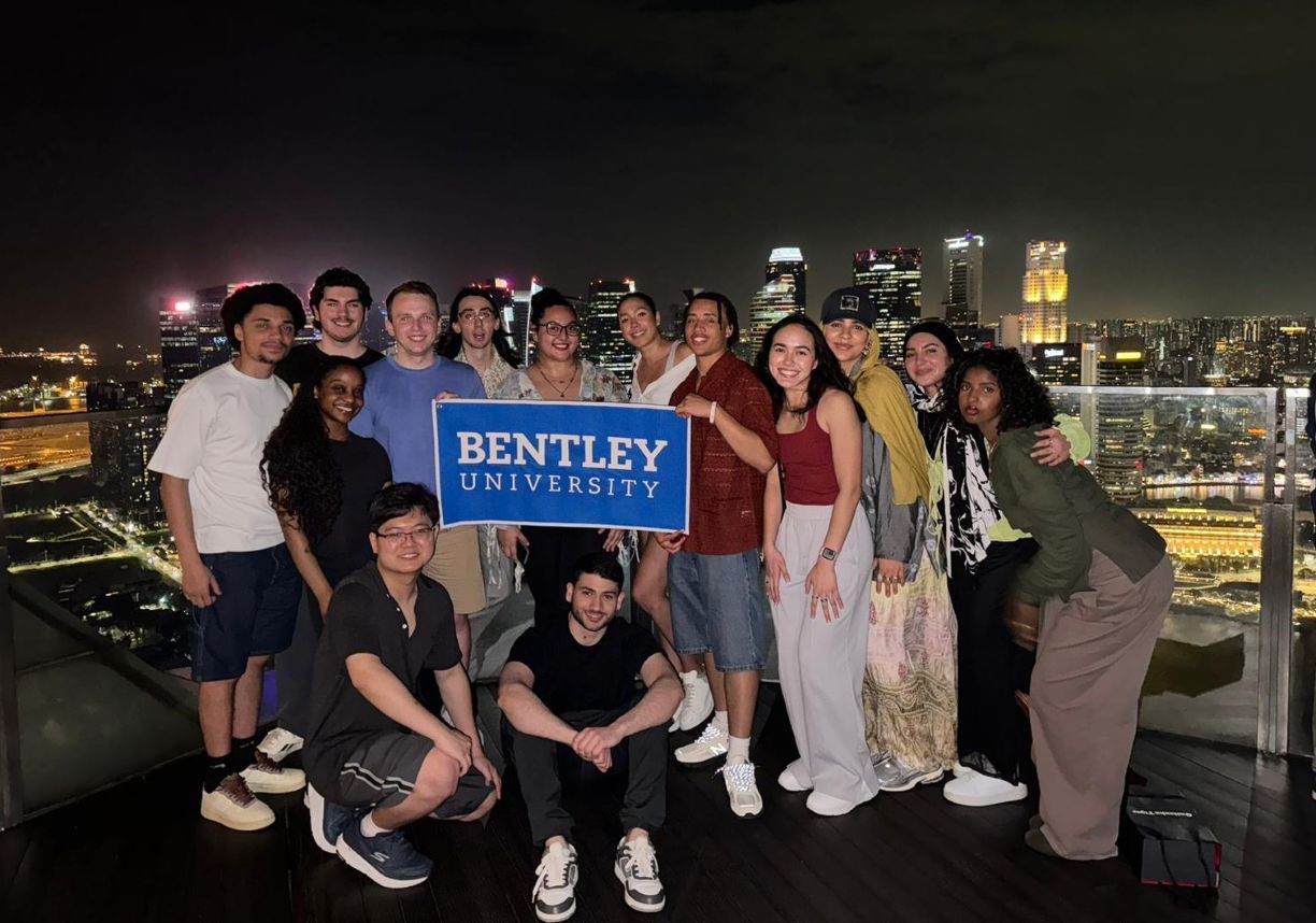 Bentley student cohort in an intensive course in Southeast Asia pose holding a Bentley sign