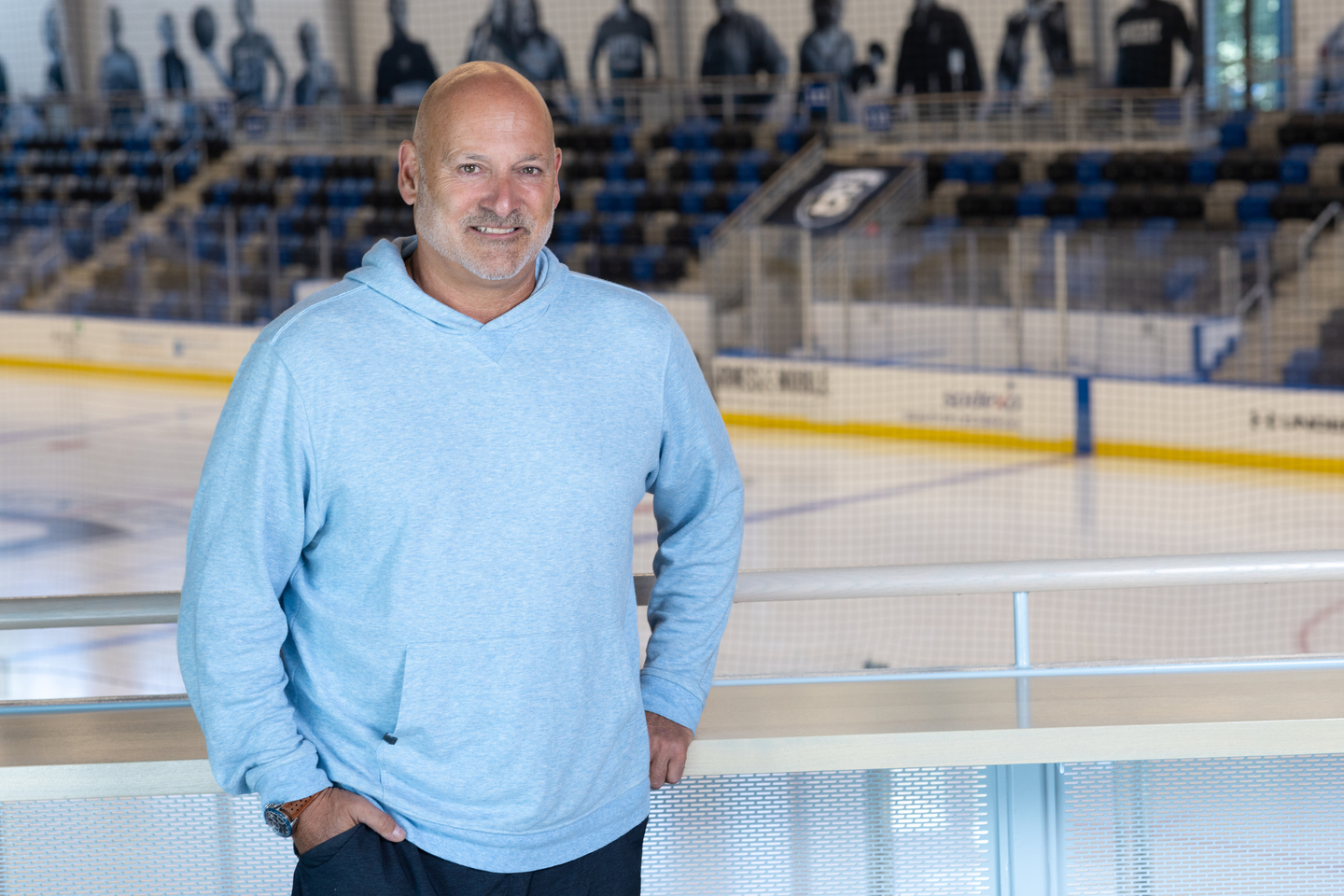 Greg Quercia standing in the Bentley Arena with the ice in the background