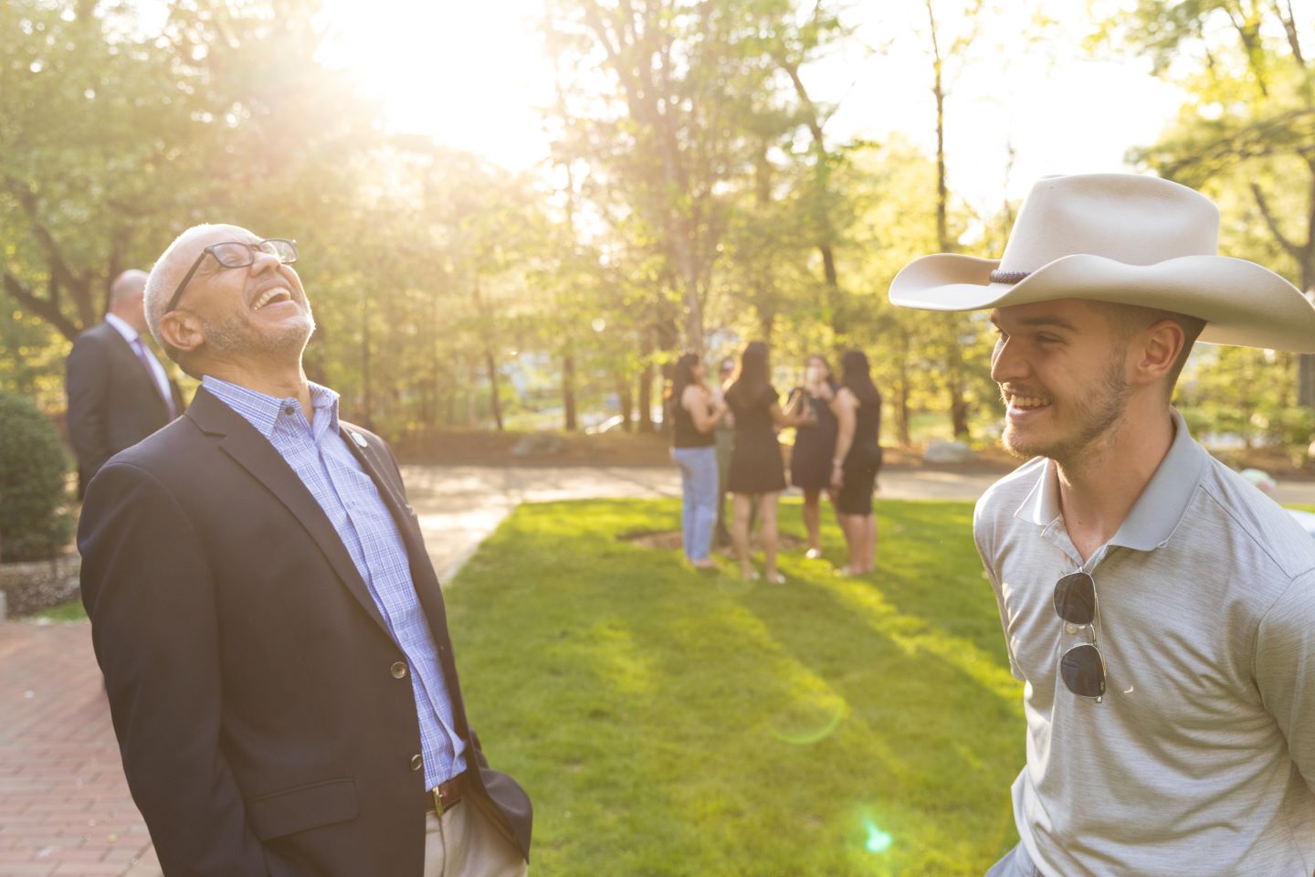 Bentley President E. LaBrent Chrite laughs as Calvin Polachek shares news