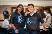 two students smile together