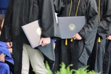 Graduates holding their diplomas