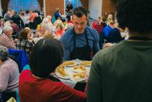 Man serving Thanksgiving meal