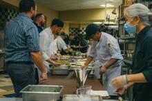 Dining hall cooks preparing Thanksgiving luncheon