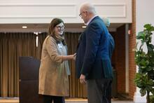 Two people shaking hands on stage