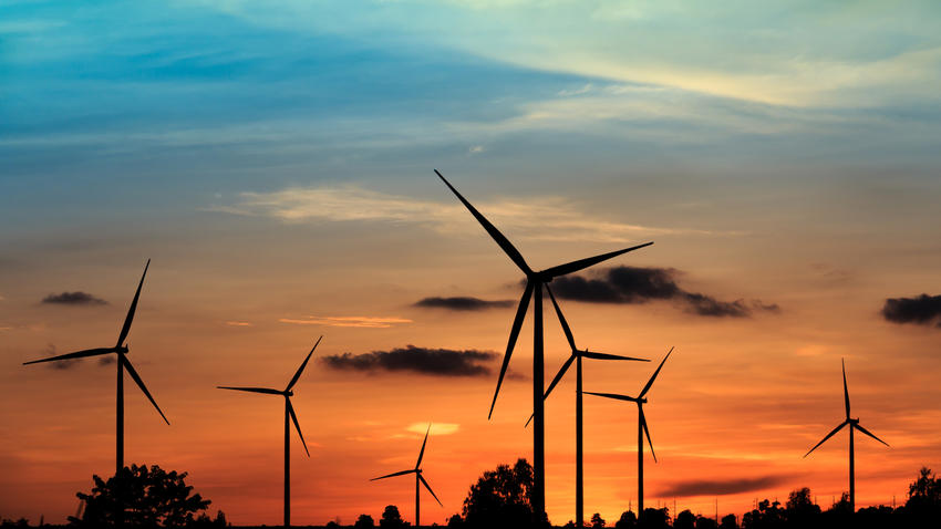 Wind farm against orange sky