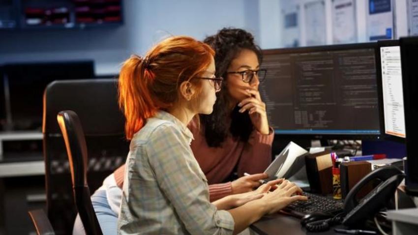 two female students work at computer