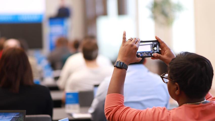 Attendee takes a photo at Bentley-Gallup Business in Society event in Washington, D.C.