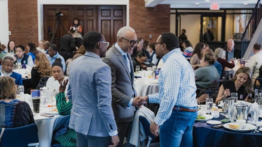 Bentley University President E. LaBrent Chrite networks with attendees at the annual Bentley University MLK social justice program  