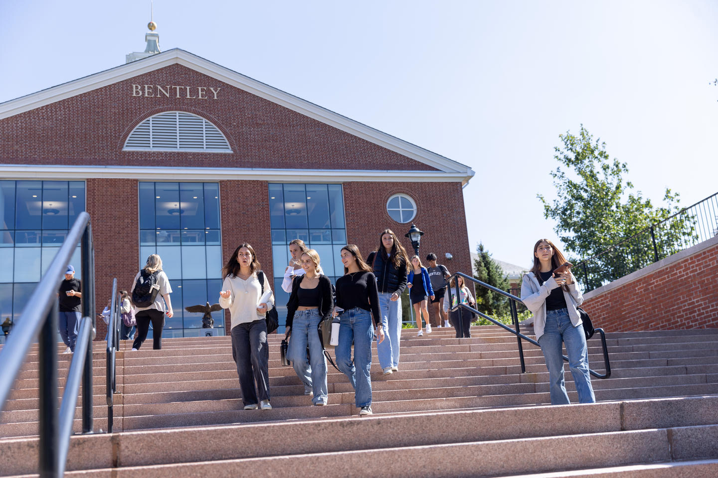 Students walking down stairs in front of Bentley University library