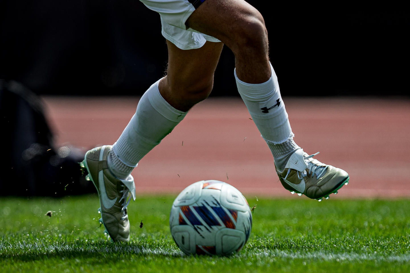 Soccer ball and players feet