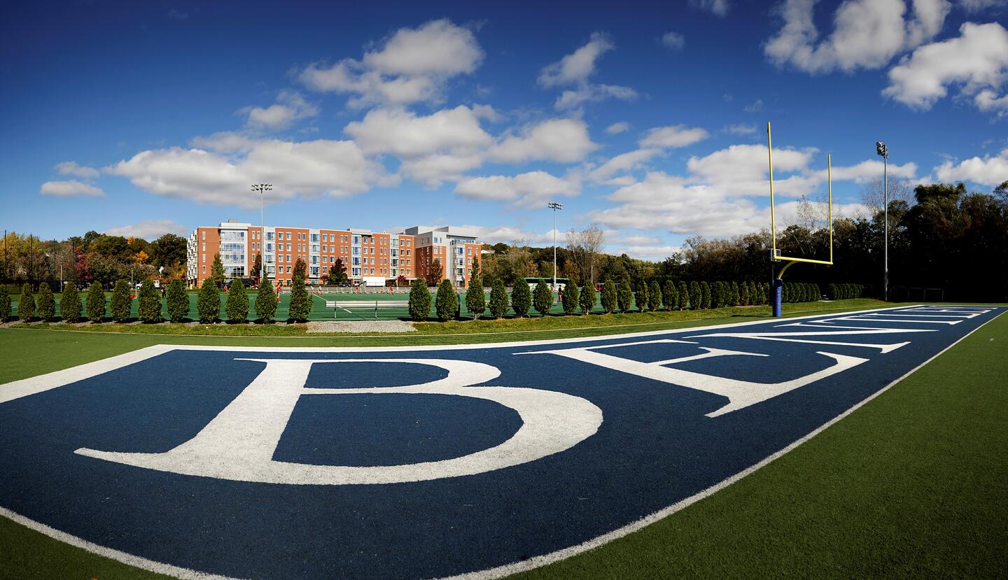 football field with fenway hall in background