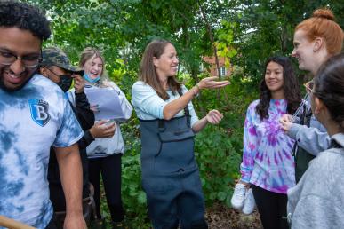 Bentley Professor Betsy Stoner and students in a pond gathering samples