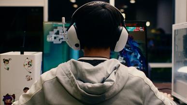Bentley student wearing headset and gaming